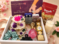 Raksha Bandhan Floral Gift Hamper with lotus wax art, earrings, perfume, chocolates and dry fruits