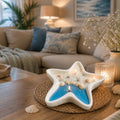 Ocean Star Soy Wax Candle displayed on coffee table in coastal living room