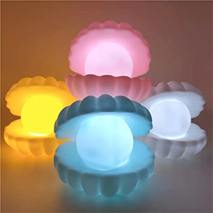 Pearl shell night lamps in pink, yellow, blue and white colours all glowing together