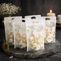 Daisy flower printed transparent ziplock stand-up pouches filled with dried flowers on marble tray