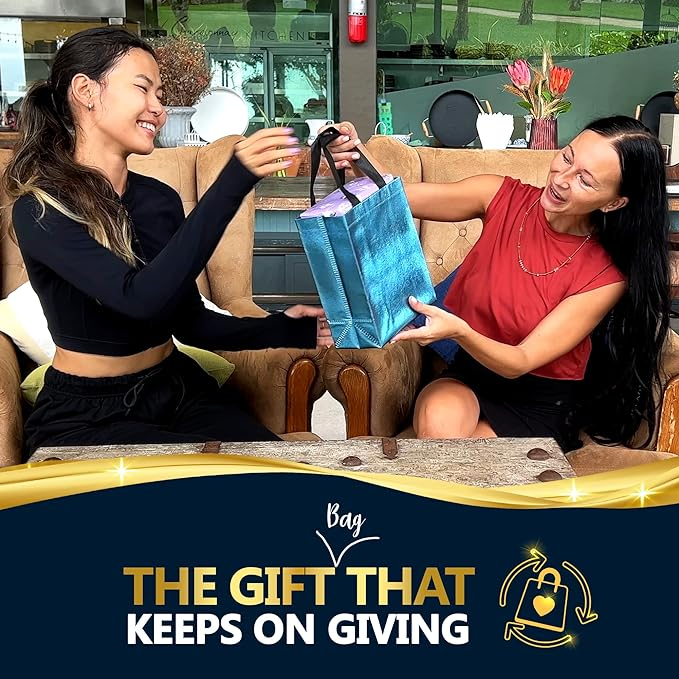 Two women exchanging a metallic blue gift bag - The gift that keeps on giving