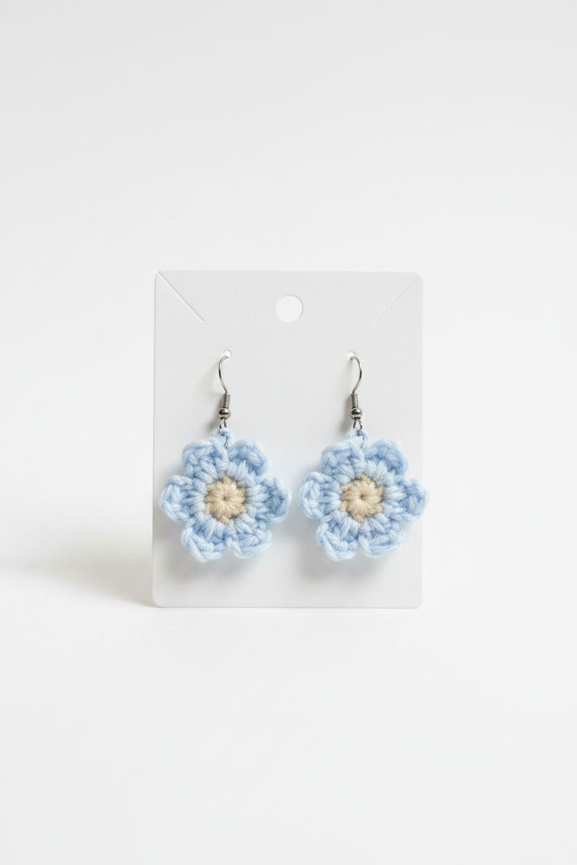 Blue crochet flower earrings on display card
