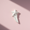 Shooting star plaster fridge magnet on pink background