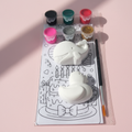 Whale and duck DIY kit flat lay on pink background