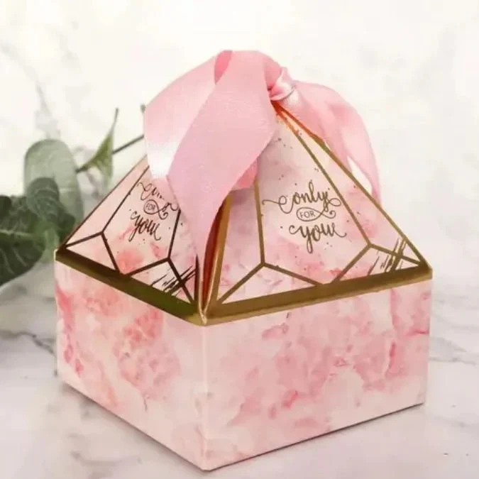 Pink marble diamond pyramid gift box with gold geometric design and pink satin ribbon bow
