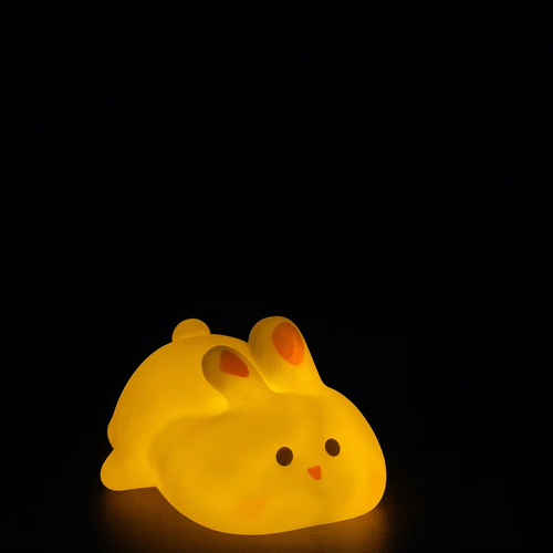 Bunny silicone night light glowing warm golden yellow in the dark