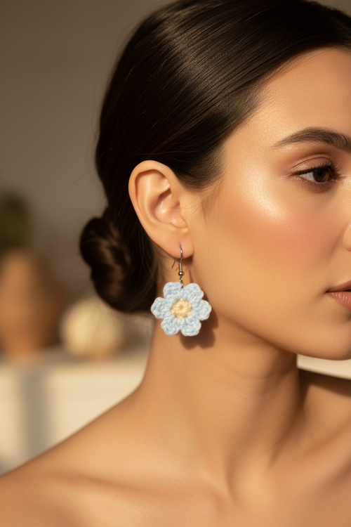 Blue crochet flower earrings worn on model