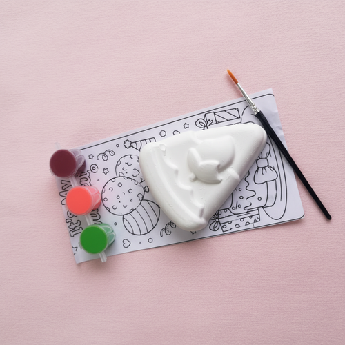 Birthday cake slice DIY fridge magnet kit flat lay on pink background