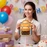 Woman holding orange cartoon backpack ziplock gift bag filled with treats