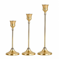 Set of 3 gold brass taper candle stands in small, medium and large sizes