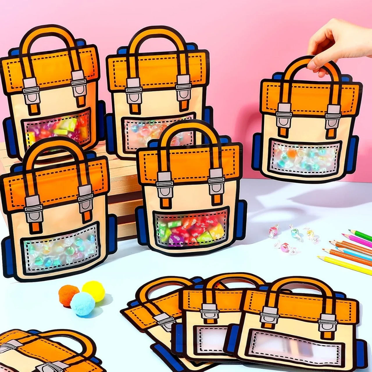 Multiple orange cartoon school backpack design ziplock gift bags filled with colourful candies on a table