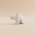 White plaster Triceratops dinosaur fridge magnet on soft light peach background