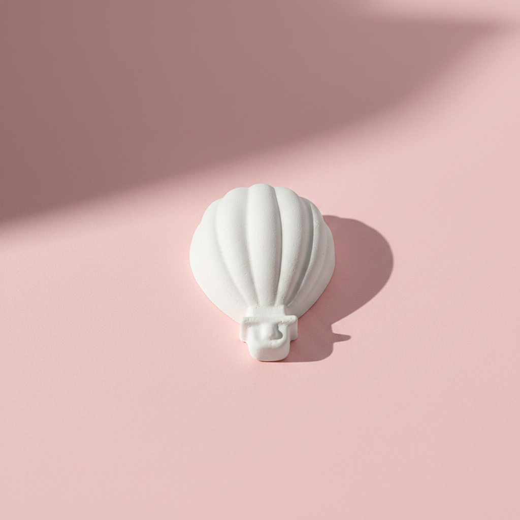 Hot air balloon plaster fridge magnet on pink background