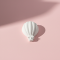 Hot air balloon plaster fridge magnet on pink background