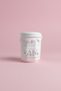 White unpainted plaster jam jar figure on pastel pink surface