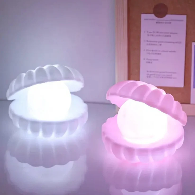 White and pink pearl shell night lamps glowing on a desk